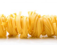 row dry nest pasta on white with reflection